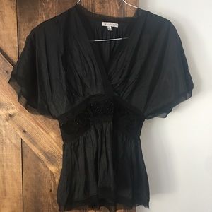 Francesca’s black blouse with rose detail